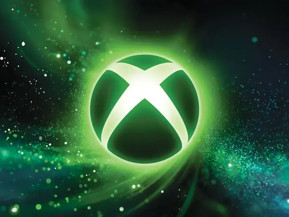 Logotipo de Xbox iluminado en verde sobre un fondo de partículas.