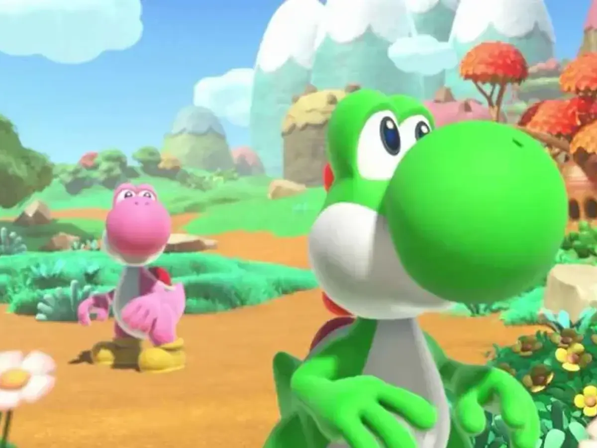 Yoshi verde recorre un paisaje colorido junto a Yoshis rosa y azul.